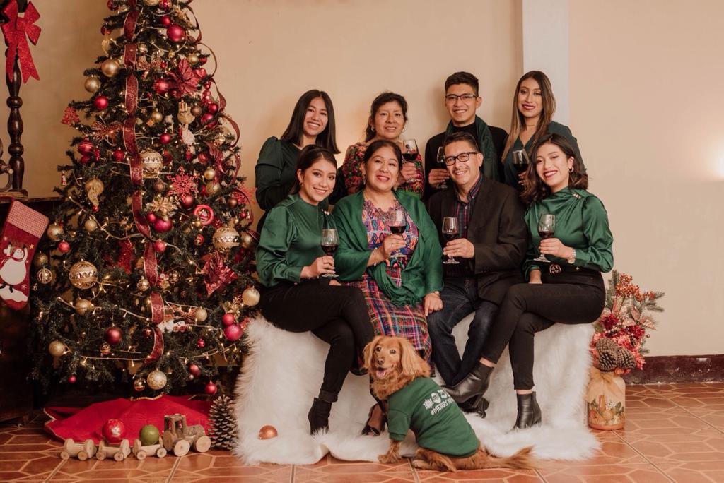 Family next to a Christmas tree